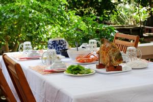 a table with a white table cloth with food on it at Ben Tre Farm Stay in Ben Tre