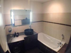 a bathroom with a sink and a bath tub at le topaze in Colmar