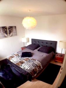 a bedroom with a large bed with a zebra blanket at le topaze in Colmar