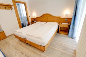 Postel nebo postele na pokoji v ubytování Hotel Garni Sottobosco
