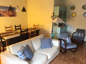 a living room with a white couch and a table at Tiagos Apartament in Faro