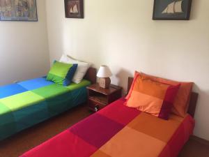 two beds sitting next to each other in a room at Tiagos Apartament in Faro
