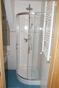 a shower with a glass door in a bathroom at Apartamenty Rodzinne in Wojciechy +105 photos