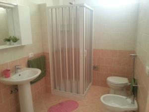 a bathroom with a shower and a toilet and a sink at Casa Gavi in Tre Fontane