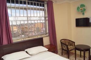 Postel nebo postele na pokoji v ubytování Diamonds Hotel Kampala