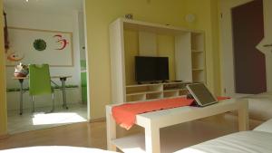 a living room with a table with a laptop on it at Apartment Vladka Koper in Koper