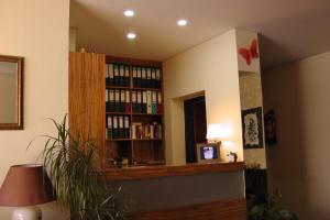 a room with a book shelf filled with books at Die Pension Reeh in Podersdorf am See