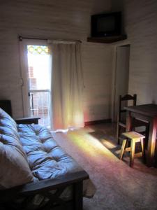 a living room with a couch and a window at Cabañas Molinos de Vientos in Potrero de los Funes