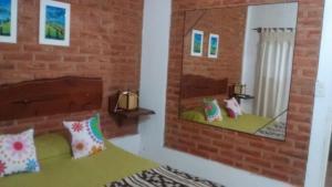 a room with two mirrors and a bed in a room at Cabañas Molinos de Vientos in Potrero de los Funes