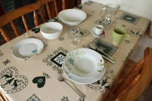 a table with plates and dishes on top of it at Chalet Presanella in Temù