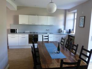 a kitchen and dining room with a wooden table and chairs at Winzerhaus Andel in Bernkastel-Kues