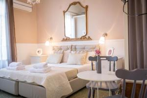 a bedroom with a bed with a mirror and a table at B&B Abbacò in Palermo