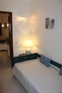 a bedroom with a bed with a lamp on it at XAVILLA 2 in Albufeira