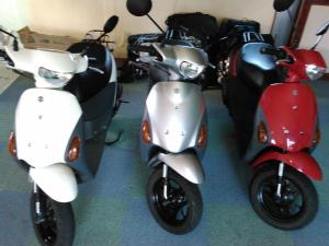 a group of scooters parked in a garage at Guest House Miyakojima in Miyako-jima