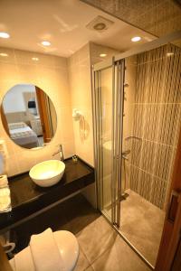 a bathroom with a sink and a shower and a mirror at City Hotel Marmaris in Marmaris