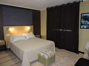 A bed or beds in a room at Cruceiro do Monte
