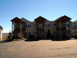 a large apartment building with a lot of windows at Klonteska Condominiums By VCI Real Estate Services in Beech Mountain +5 photos
