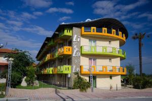 a building with colorful balconies on the side of it at Lilalo Ηotel in Paralia Katerinis