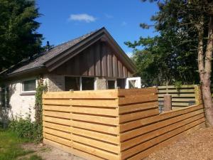 a wooden fence in front of a house at Texelduinen59 in De Koog +7 photos