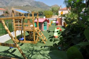 a backyard with a playground and a play house at Terra Mia in Formia