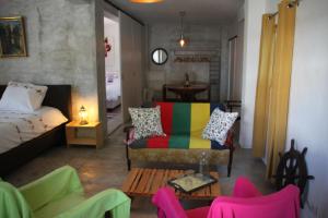 a room with a bed and a couch and a table at Casa do Loureiro Branco in Santarém +22 photos
