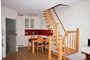 a kitchen and dining room with a wooden table and stairs at Ferienwohnung Benediktenwand in Lenggries +11 photos