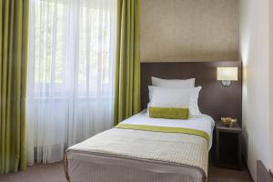 Postel nebo postele na pokoji v ubytování Hotel Alex