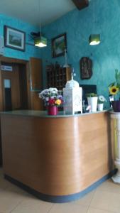 a counter in a restaurant with flowers on it at PICO SACRO II HOTEL Santiago de Compostela in Santiago de Compostela