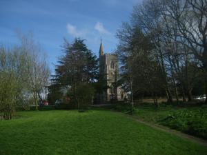 una vecchia chiesa con un campanile in un parco di The Benett Arms a Shaftesbury