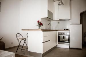 a kitchen with white cabinets and a white refrigerator at Dalmato in Split