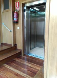 a elevator with a glass door in a building at PICO SACRO II HOTEL Santiago de Compostela in Santiago de Compostela