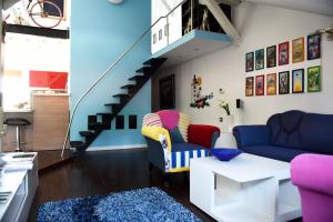 a living room with two couches and a staircase at Zagreb Rooftops in Zagreb
