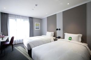 Rúm í herbergi á G2 Hotel Myeongdong