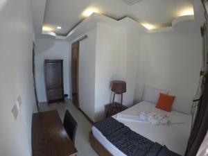 Postel nebo postele na pokoji v ubytování El Nido Royal Palm Inn