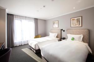 Rúm í herbergi á G2 Hotel Myeongdong
