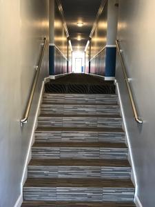 
a stairway leading up to a room with stairs at Relax Inn in Los Angeles
