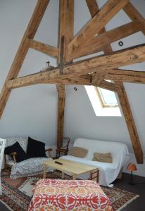 a attic room with a bed and a table at Le Chalande in Autrans