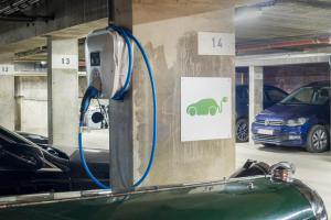 a charging station in a parking garage with cars at Dukes' Academie Brugge - by Dukes' Hotel Collection in Bruges
