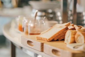 a table topped with slices of bread on a cutting board at New Space Hotel Airport in Ho Chi Minh City