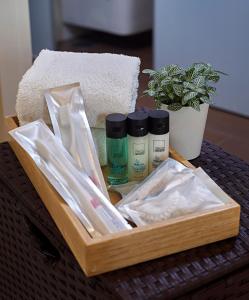 a wooden tray with products on a table at Oasia Suites Kuala Lumpur by Far East Hospitality in Kuala Lumpur