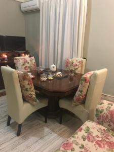 a dining room with a wooden table and chairs at Mà Maison in Caserta