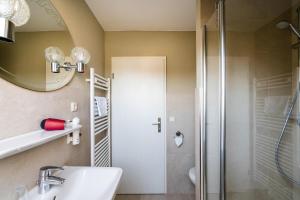 a bathroom with a shower and a sink and a mirror at Hotel Marianne und Restaurant Kiek In in Plau am See