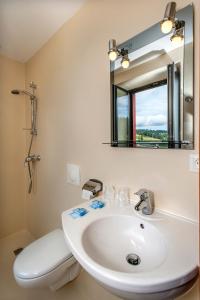a bathroom with a white sink and a mirror at Hotel de France in Chaudeyrac +24 photos