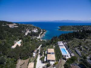 an aerial view of a resort with a pool and the ocean at Paxos Santa Marina Villas in Gaios