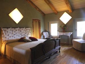 a bedroom with a large bed and two windows at Guest house Cascina Belsito in Biella