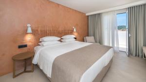 Postel nebo postele na pokoji v ubytování Bitzaro Grande Hotel & Suites