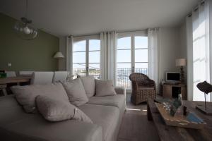 a living room with a white couch and a table at Port rive gauche Gabian in Marseillan
