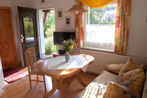 a living room with a table and a couch at Ferienhaus "Morgensonne" in Kurort Gohrisch