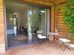 a patio with sliding glass doors and a table and chairs at Hotel Fundació L'Olivar in Ventalló