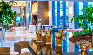 a table with three glasses on it in a restaurant at Porto Platanias Beach Resort & Spa in Plataniás